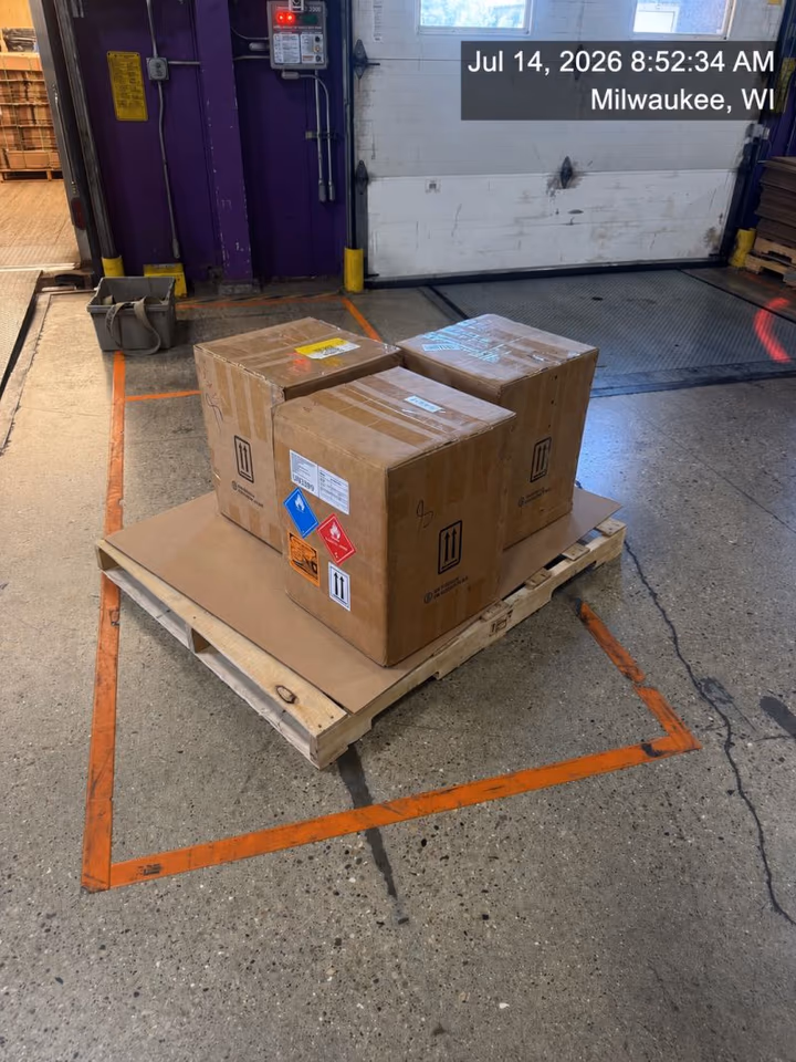 Palletized cartons placed inside a marked receiving bay at a Milwaukee, Wisconsin dock after a dedicated delivery from O’Hare